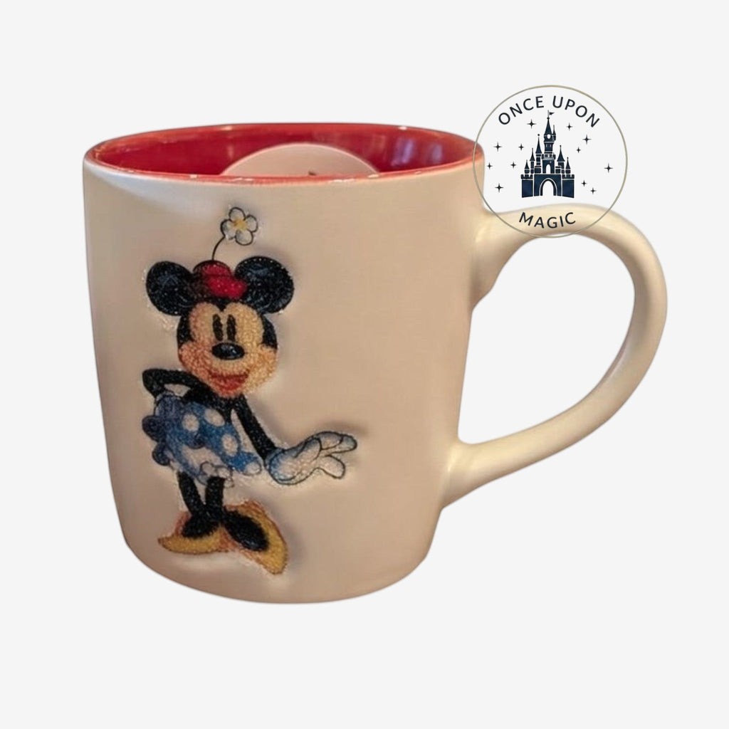 Once Upon Magic white ceramic mug with red interior featuring Minnie Mouse illustration and Disneyland Paris logo.