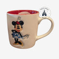 Once Upon Magic white ceramic mug with red interior featuring Minnie Mouse illustration and Disneyland Paris logo.