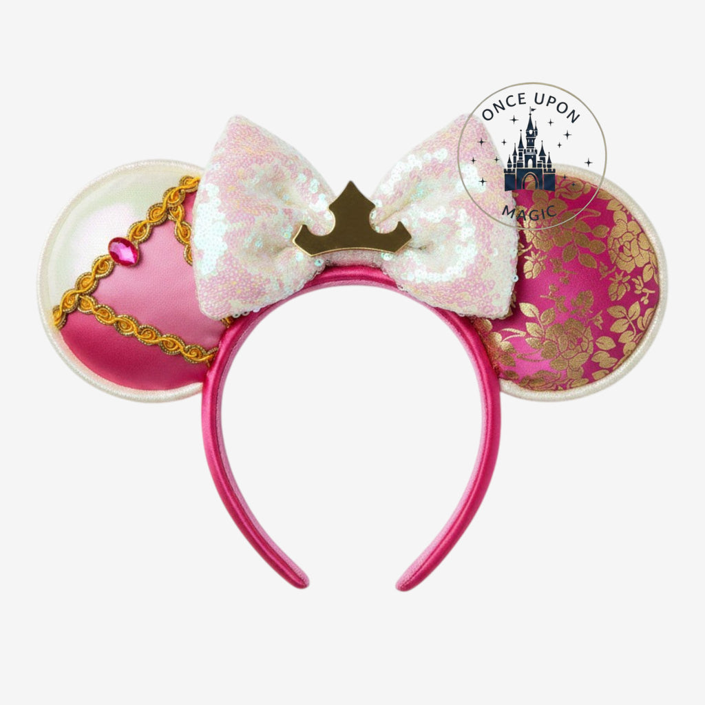 Once Upon Magic Minnie Mouse ears headband in pink satin and gold with an iridescent sequin bow and crown detail.