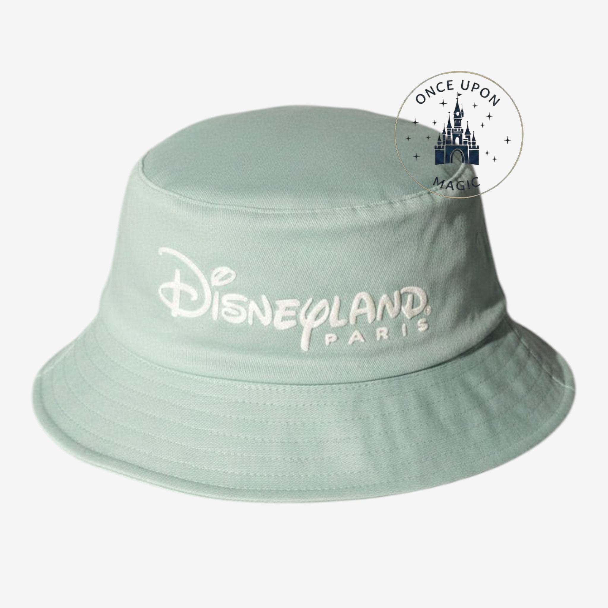 Once Upon Magic mint green cotton bucket hat with white embroidered Disneyland Paris logo and side tag.