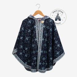 Once Upon Magic navy hooded poncho wrap with light floral pattern, decorative button, and contrasting trim on hanger.