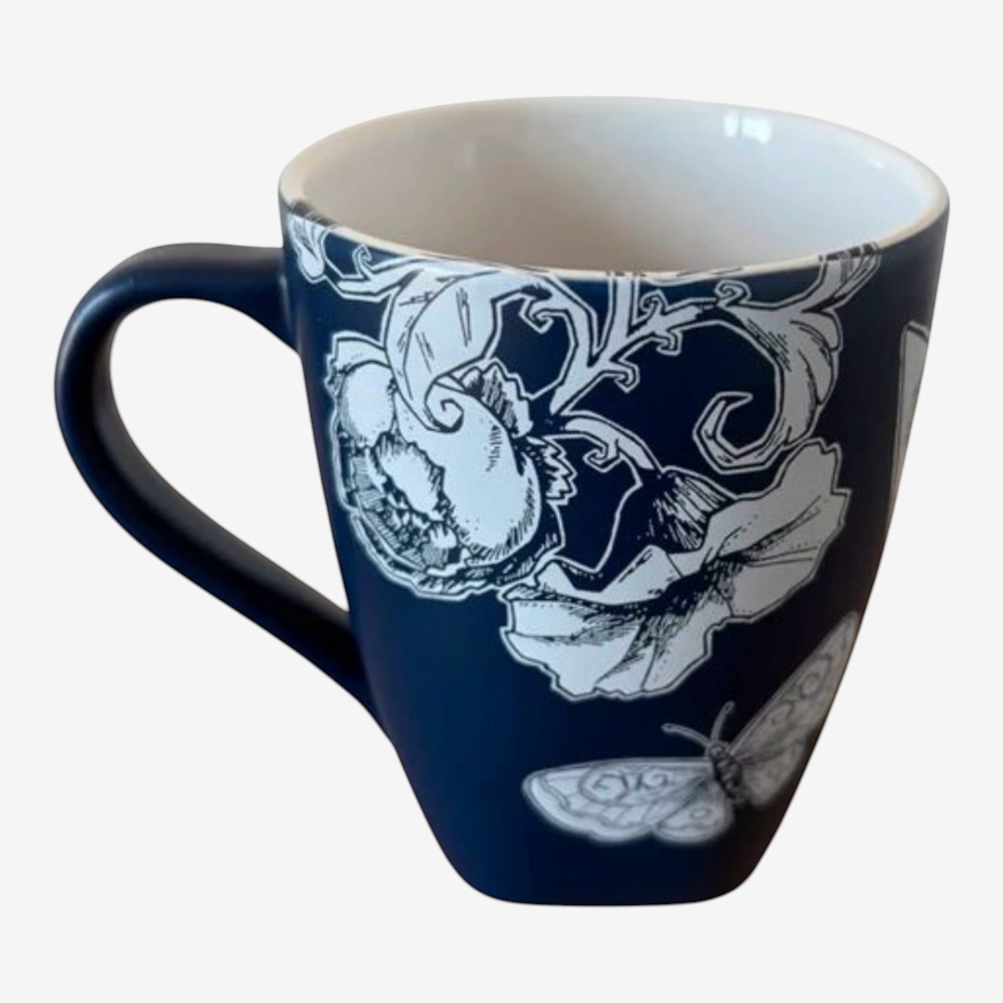 Once Upon Magic navy ceramic mug with white floral and butterfly illustration, featuring Tinkerbell.