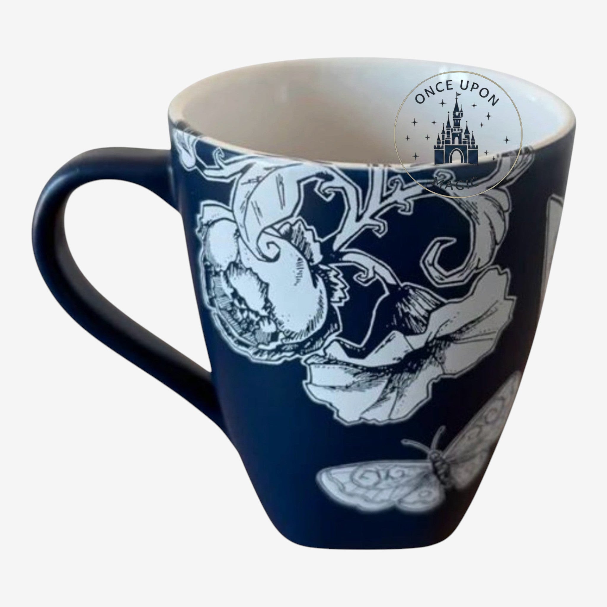 Once Upon Magic navy ceramic mug with white floral and butterfly illustration, featuring Tinkerbell.