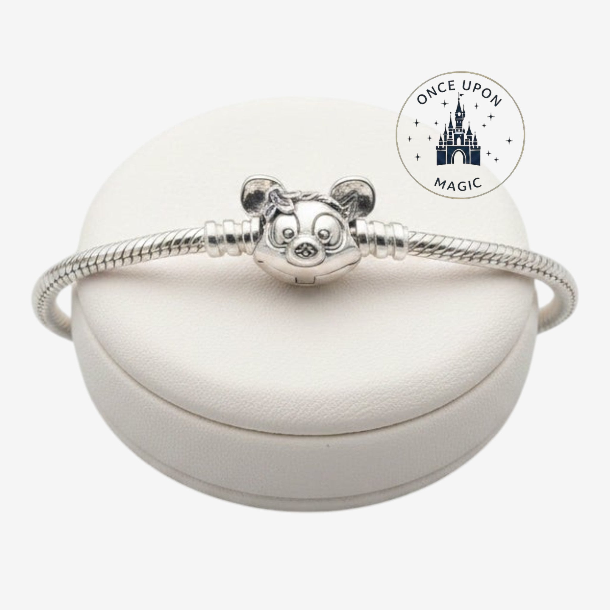 Once Upon Magic silver Pandora Disney Parks charm bracelet with a character clasp on a white display stand.