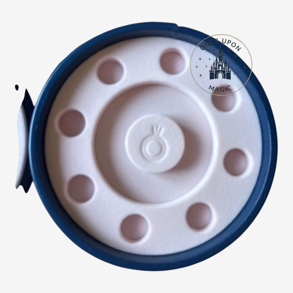Once Upon Magic round Pandora jewelry box with a navy blue exterior and light pink interior ring holder insert.