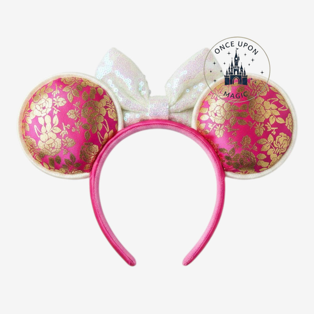 Once Upon Magic Minnie Mouse ears headband in pink satin with gold floral patterns and an iridescent sequin bow.