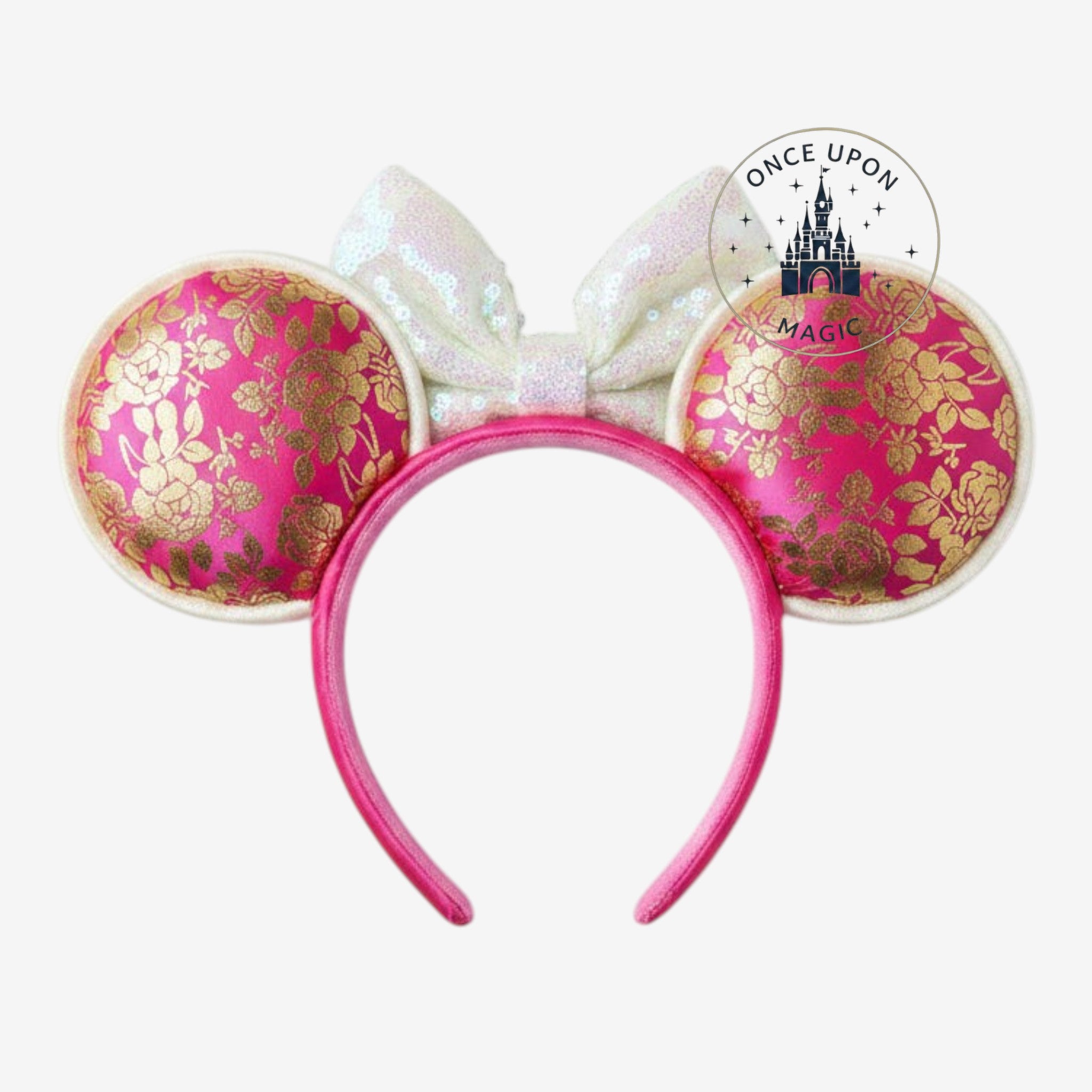 Once Upon Magic Minnie Mouse ears headband in pink satin with gold floral patterns and an iridescent sequin bow.