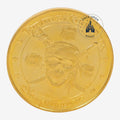 Once Upon Magic gold Pirates of the Caribbean collector coin from Disneyland Paris featuring a skull and crossbones