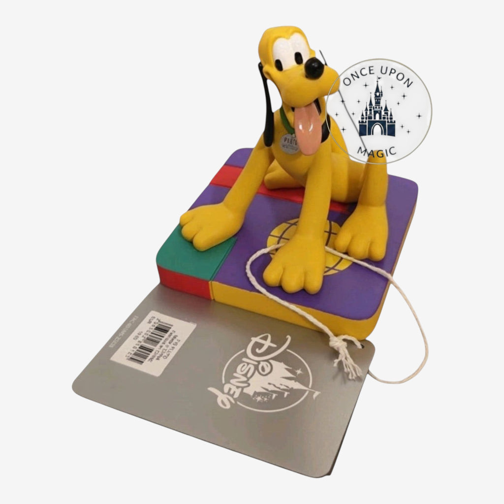 Once Upon Magic Pluto figurine featuring the yellow Disney dog sitting on a colorful base with a rope toy