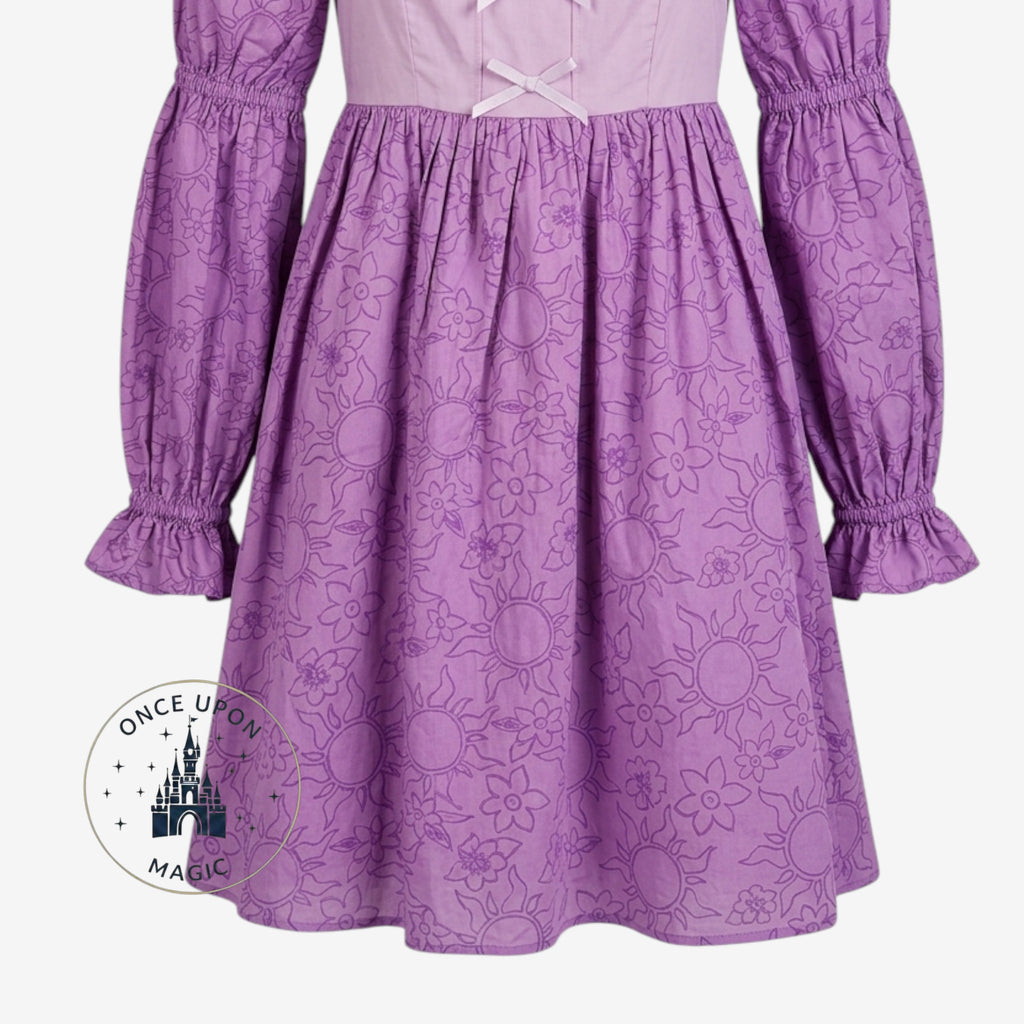 Once Upon Magic purple and pink Rapunzel dress with sun and floral print, square neckline, and puffed sleeves.