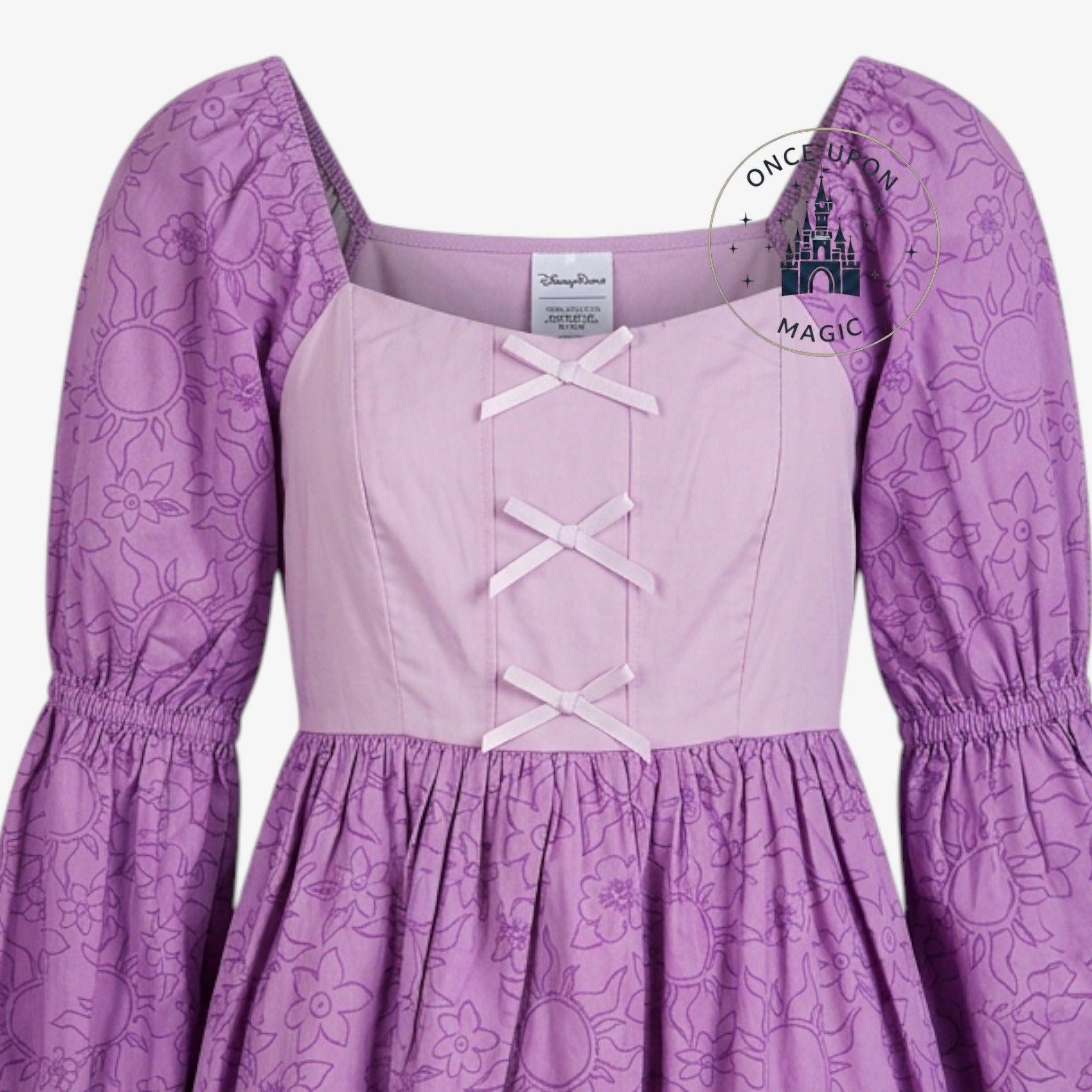 Once Upon Magic purple and pink Rapunzel dress with sun and flower print, puff sleeves, and lace-up bodice.