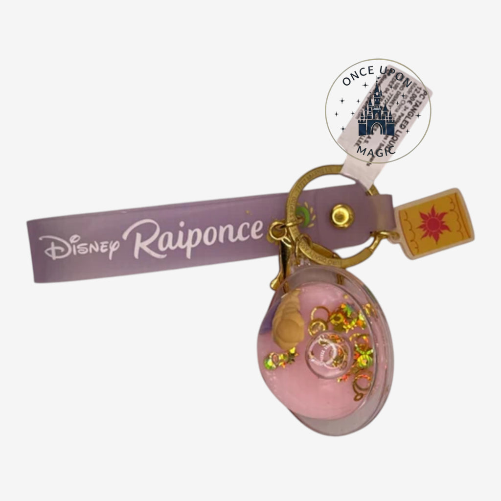Once Upon Magic Rapunzel keychain with glitter and a sun charm. Purple strap says Disney Rapunzel.