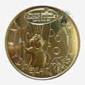 Once Upon Magic gold coin featuring Remy from Ratatouille, Disneyland Paris, with cheese details.