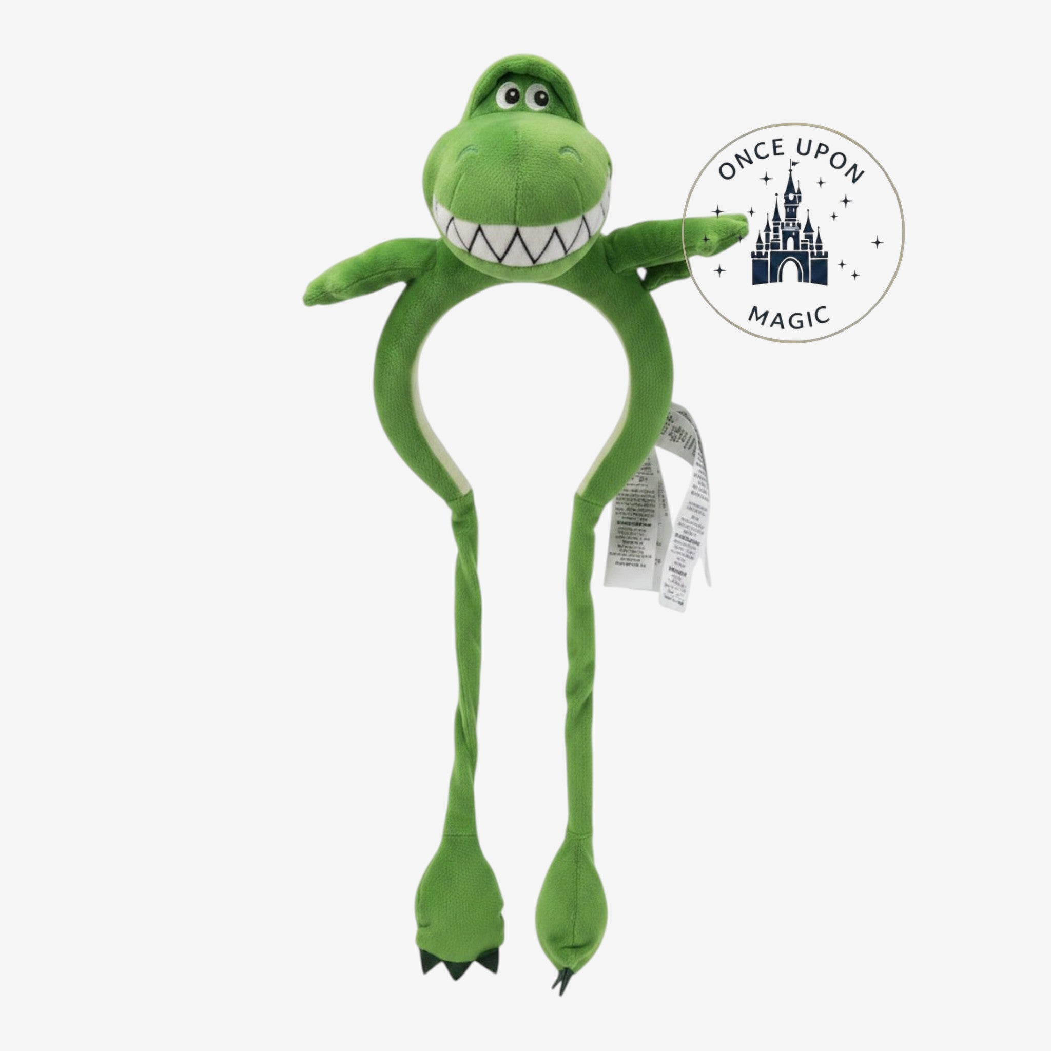 Once Upon Magic green plush Rex dinosaur headband with a toothy grin and dangling arms for interactive play.
