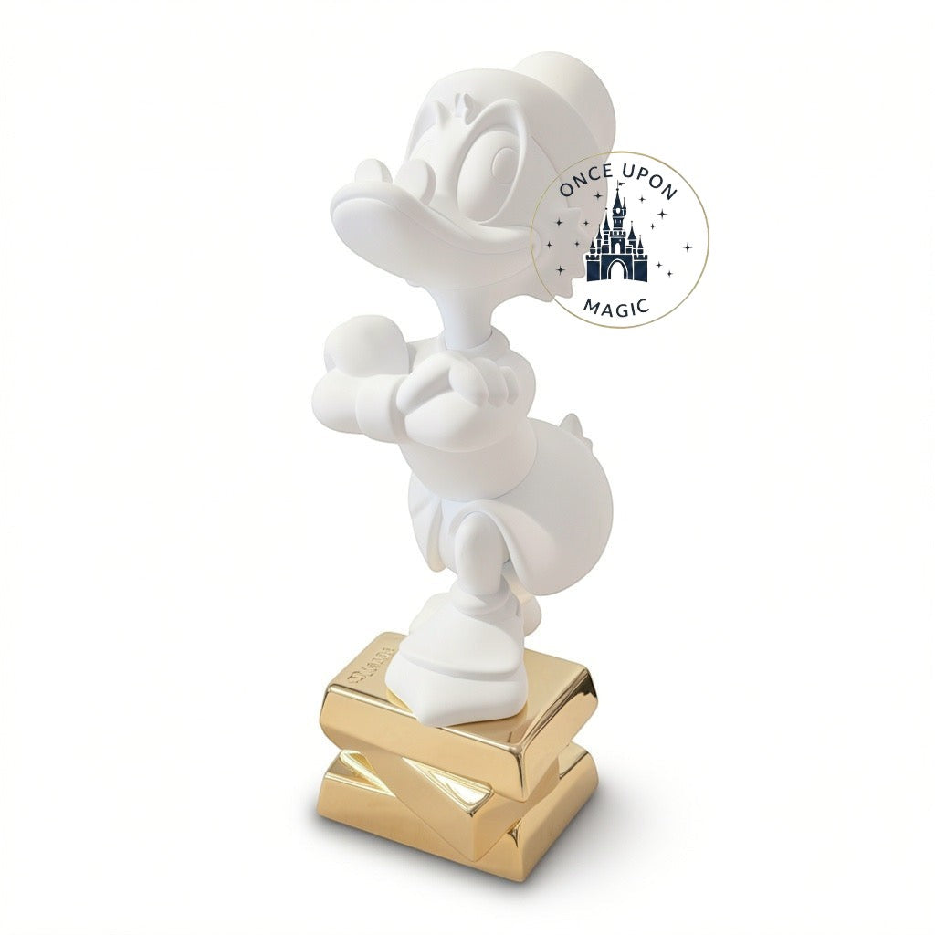 Once Upon Magic collectible white Scrooge McDuck figurine by Leblon Delienne standing on a gold base