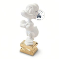 Once Upon Magic collectible white Scrooge McDuck figurine by Leblon Delienne standing on a gold base