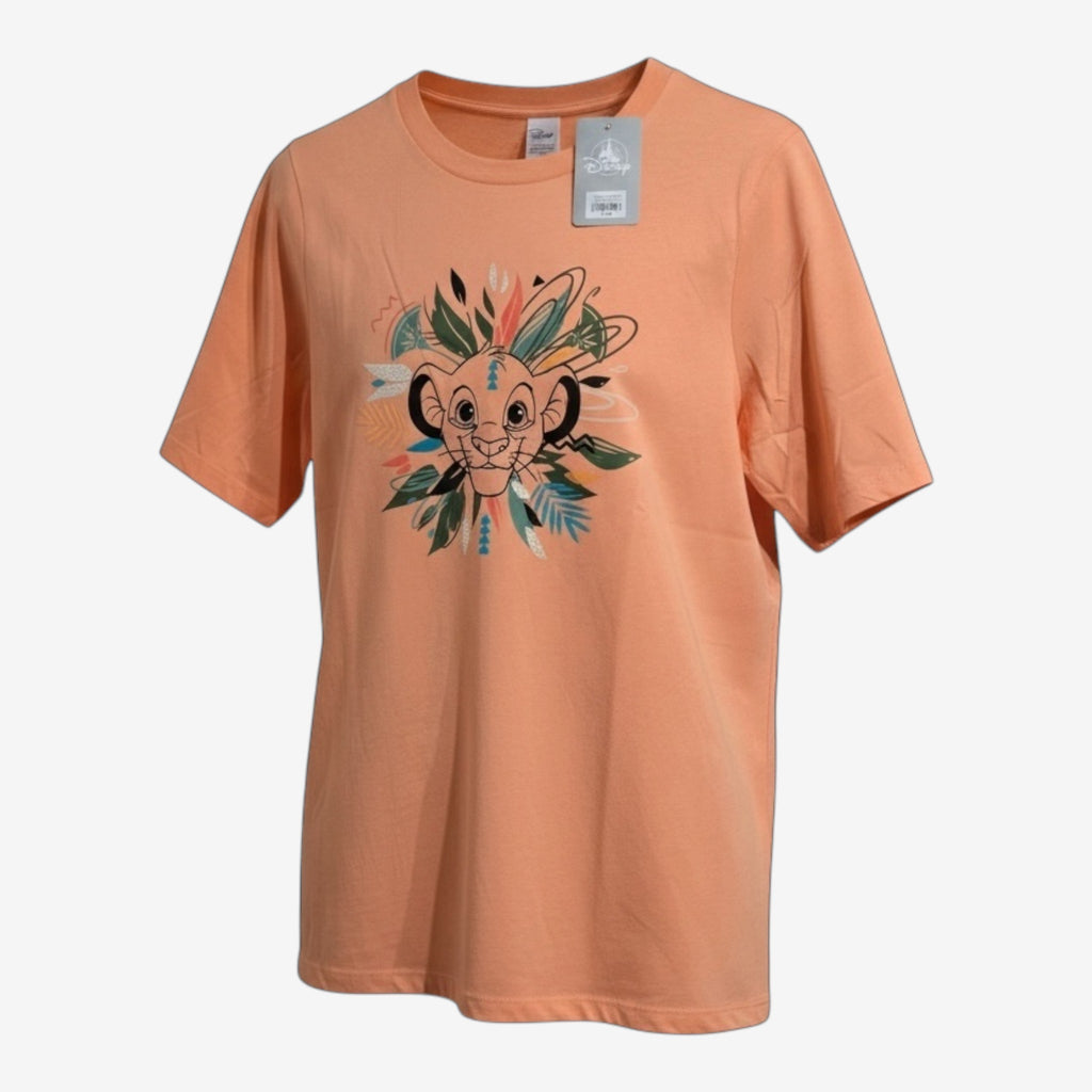 Once Upon Magic peach cotton t-shirt with a graphic of young Simba surrounded by colorful leaves and tribal patterns.