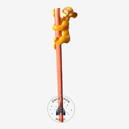 Once Upon Magic Disneyland Paris Simba pencil featuring a 3D yellow lion cub figure climbing a pink wooden pencil.