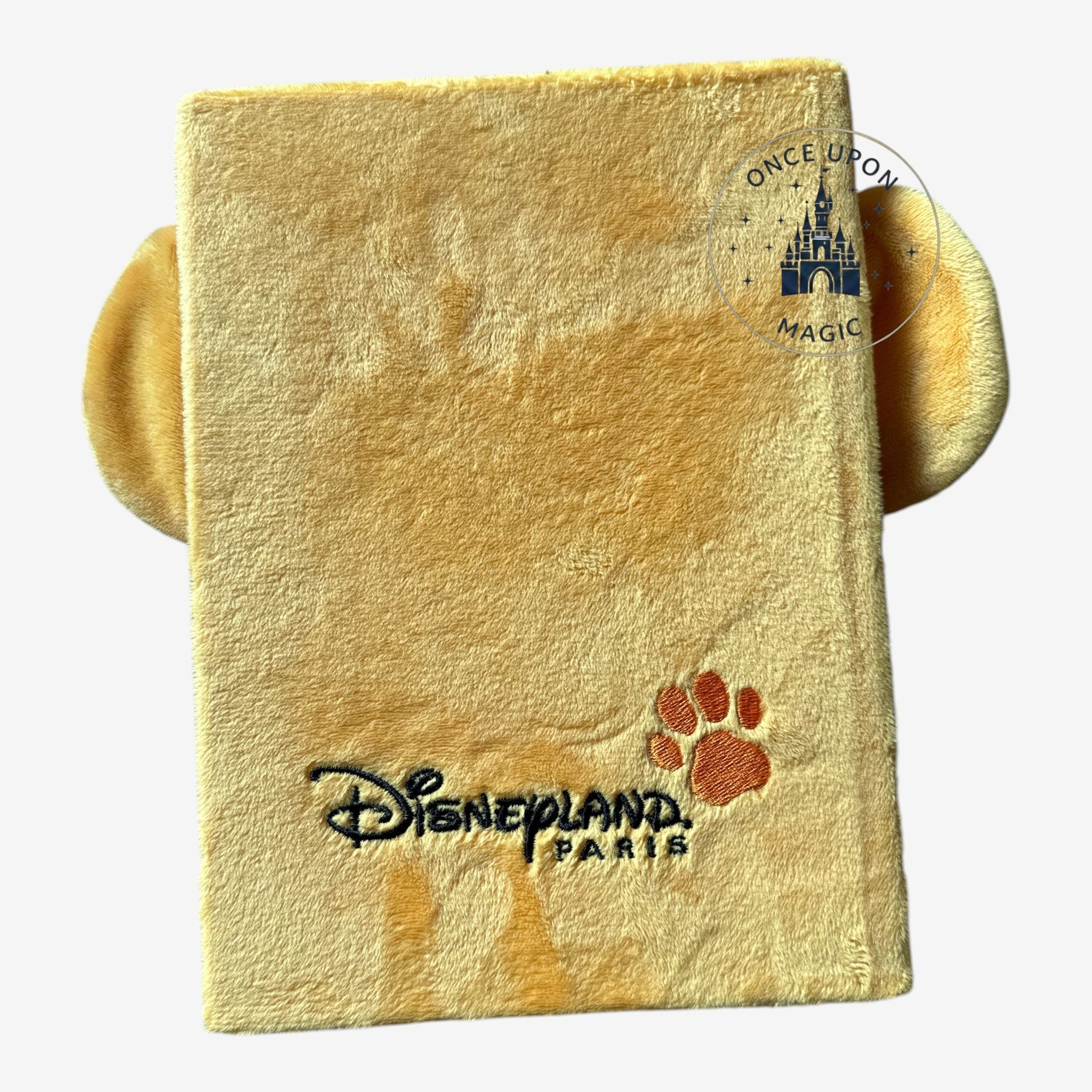 Once Upon Magic yellow plush Simba notebook with Disneyland Paris logo and paw print.