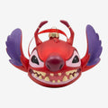Once Upon Magic red Stitch Christmas ornament with purple wings and devil horns, detailed teeth, and a festive ribbon.