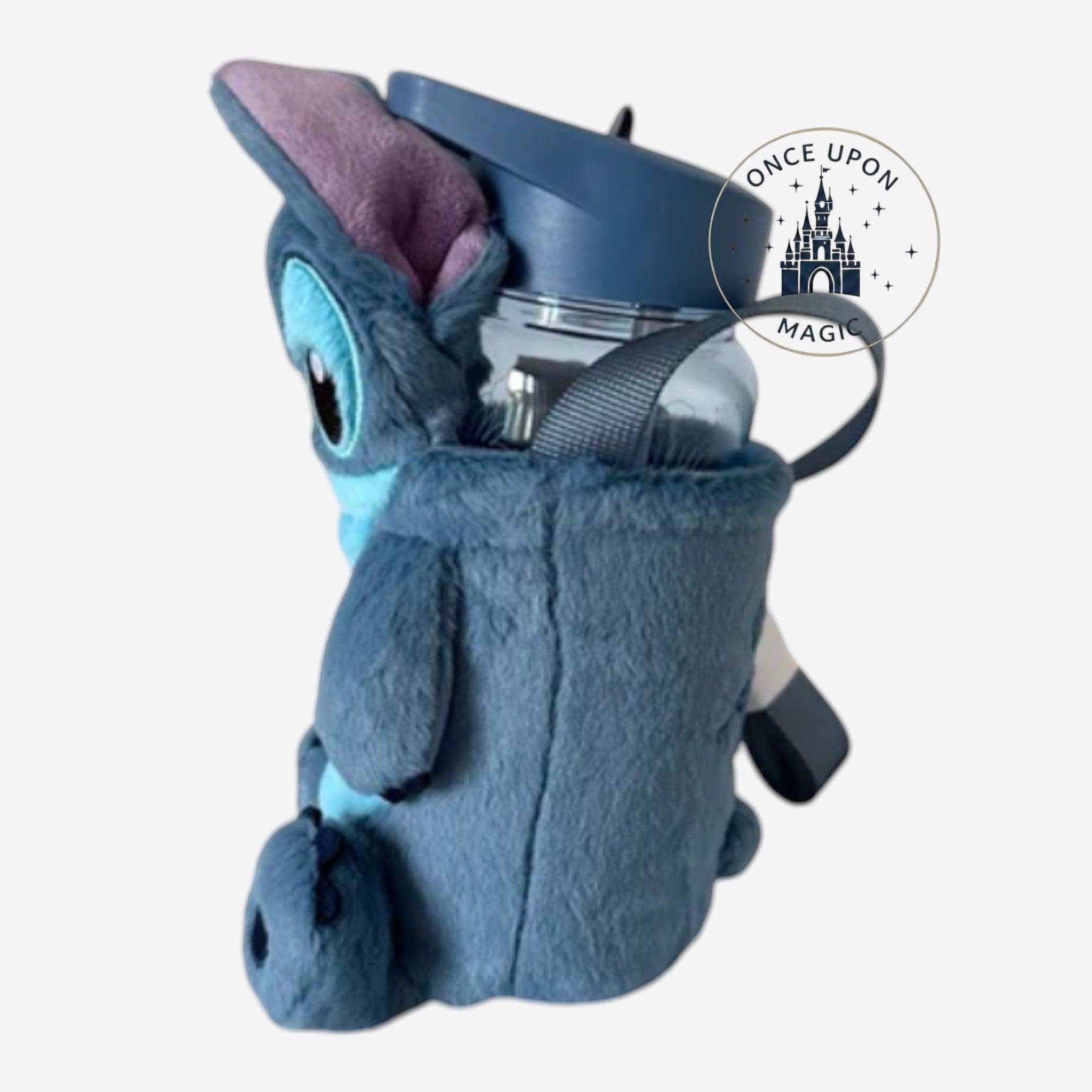 Once Upon Magic blue Stitch plush water bottle carrier with an adjustable strap on a white rotating display stand.