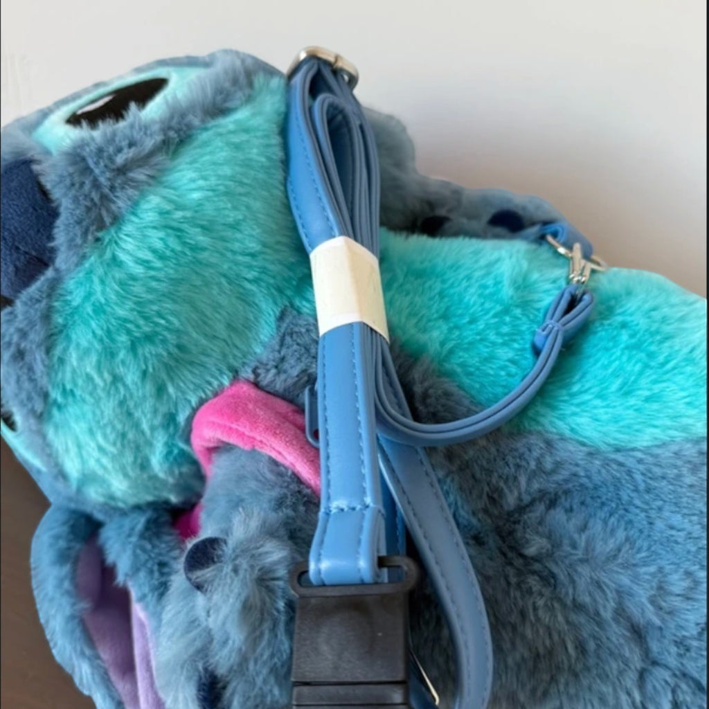 Once Upon Magic Stitch plush crossbody bag in blue and teal with an adjustable shoulder strap and pink detail.