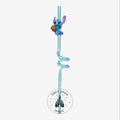 Once Upon Magic blue translucent spiral reusable straw with a Stitch figurine holding a brown object.