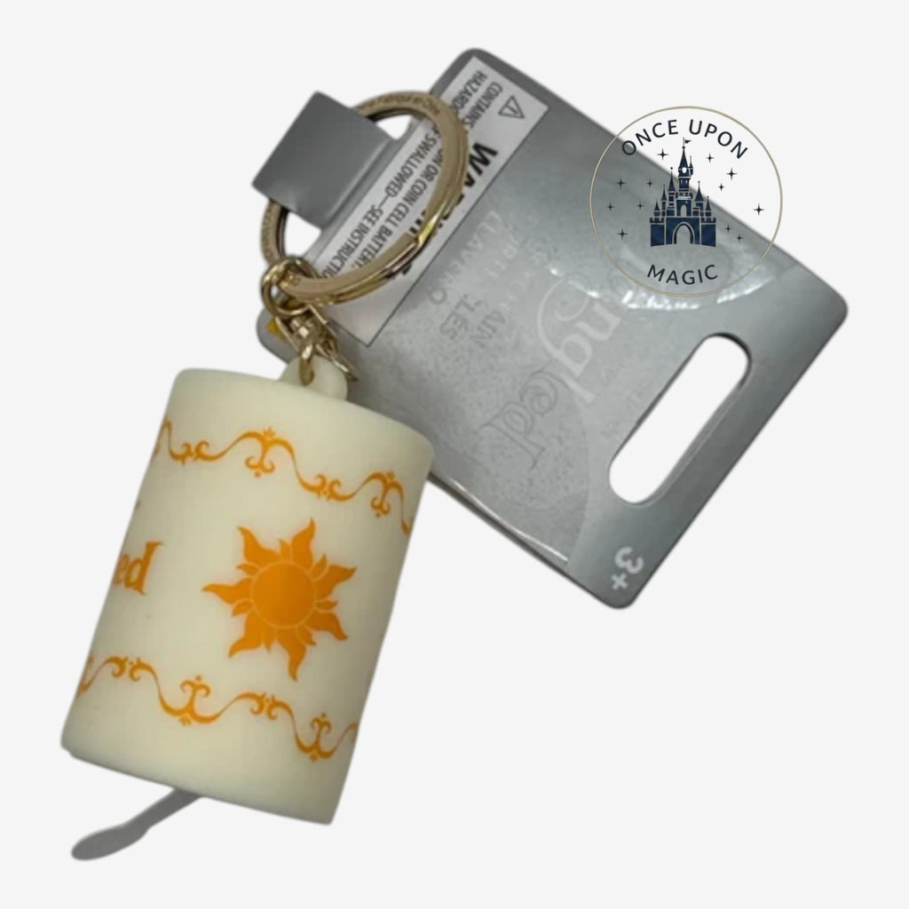 Once Upon Magic Tangled lantern-shaped keychain with orange sun emblem and decorative swirls, lights up.