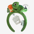Once Upon Magic green plush headband with Pascal the chameleon and a sun-decorated paint pot from Tangled.