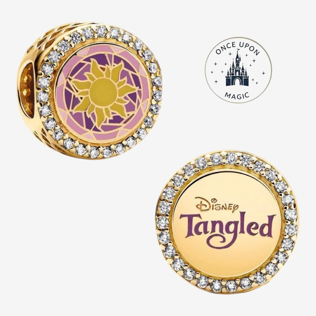 Once Upon Magic gold charm with sun design and cubic zirconia, featuring Disney's Tangled logo.