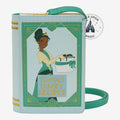 Once Upon Magic light blue faux leather crossbody bag designed as a storybook with Princess Tiana illustration and "Tiana's Family Recipes" title.