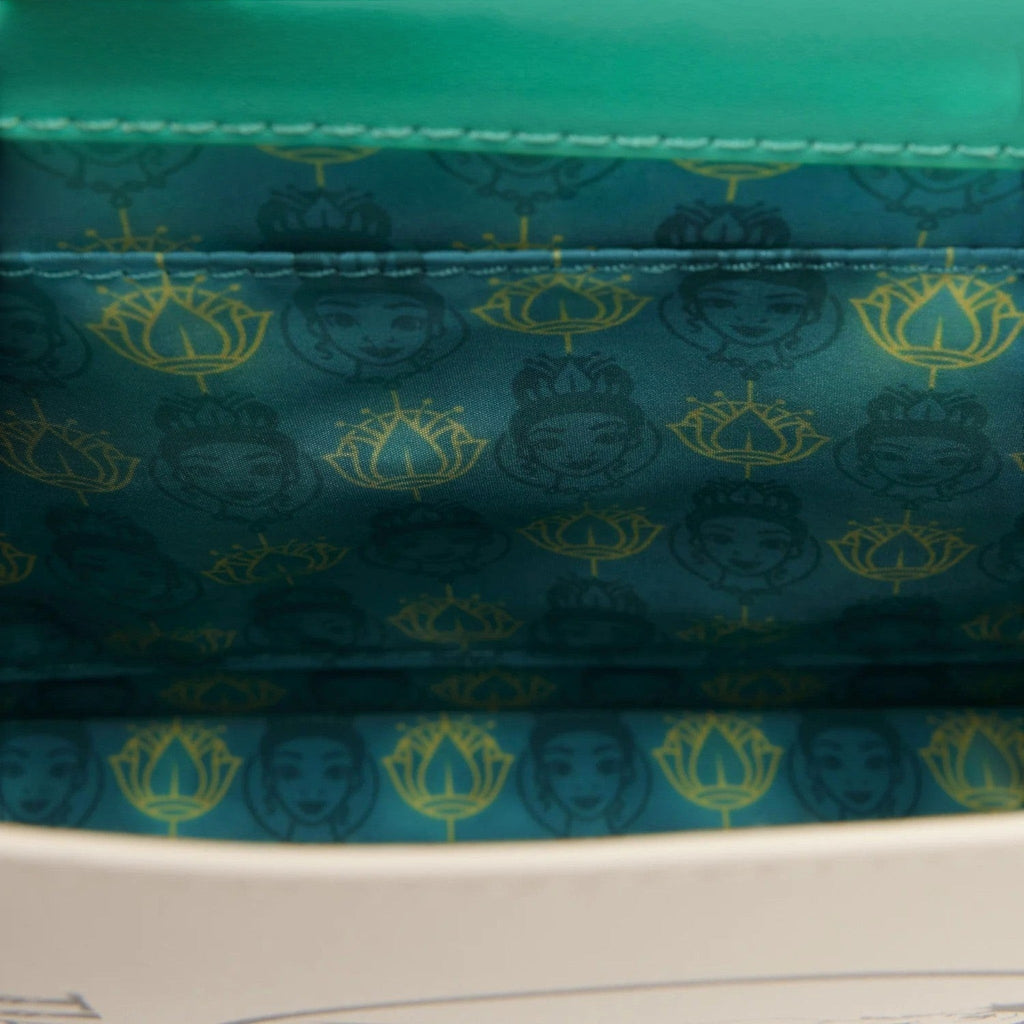 Once Upon Magic Tiana storybook crossbody bag interior with teal lining featuring Princess Tiana and lotus pattern.