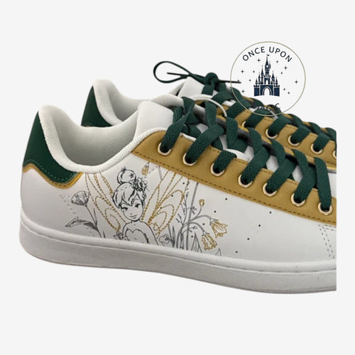 Once Upon Magic Tinkerbell white sneakers with green laces and gold accents. Features Tinkerbell graphic and floral details.