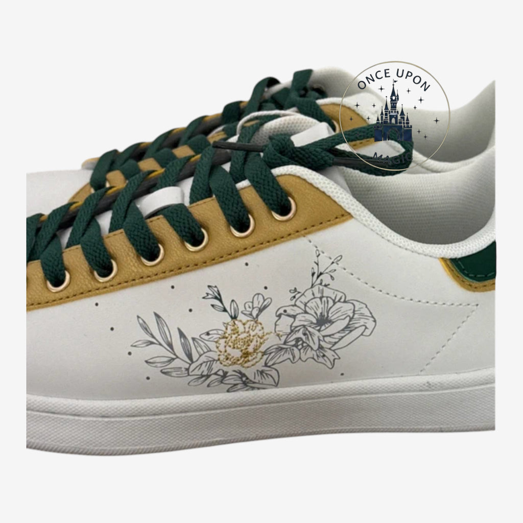 Once Upon Magic white low-top sneakers with green laces, gold accents, and Tinkerbell floral graphics.