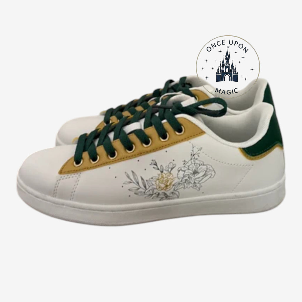 Once Upon Magic white low-top sneakers with green laces, gold trim, and floral line art. Green heel accent.