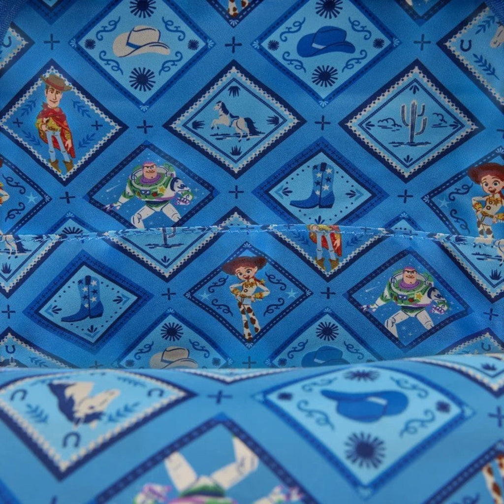 Once Upon Magic Toy Story backpack lining with Woody, Buzz, Jessie, horses, boots, and cowboy hats on blue diamond pattern.