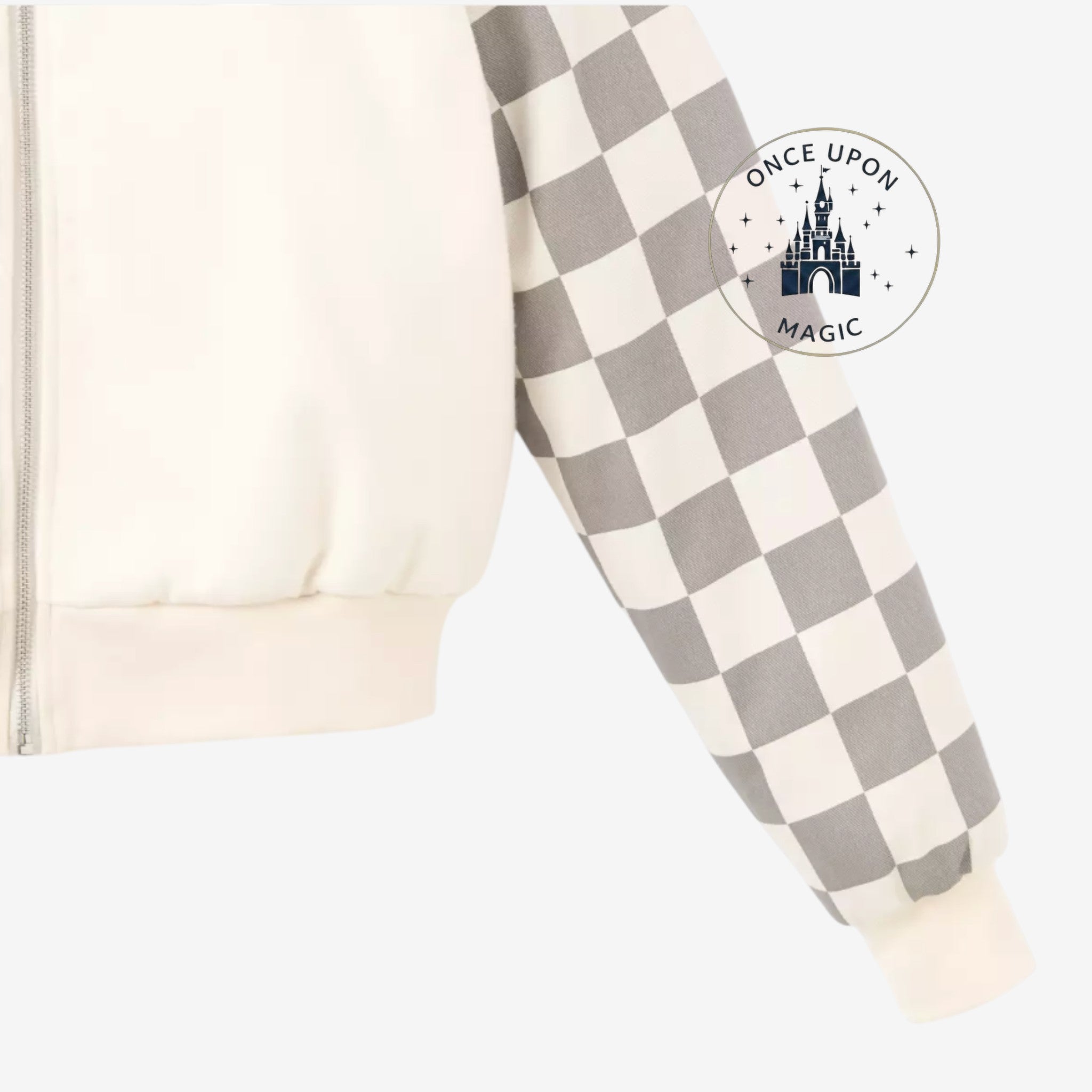 Once Upon Magic cream teddy varsity jacket with grey checkered sleeves, featuring a zipper closure and ribbed cuffs.
