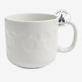 Once Upon Magic white ceramic mug from Disneyland Paris featuring a subtle embossed Mickey Mouse icon pattern
