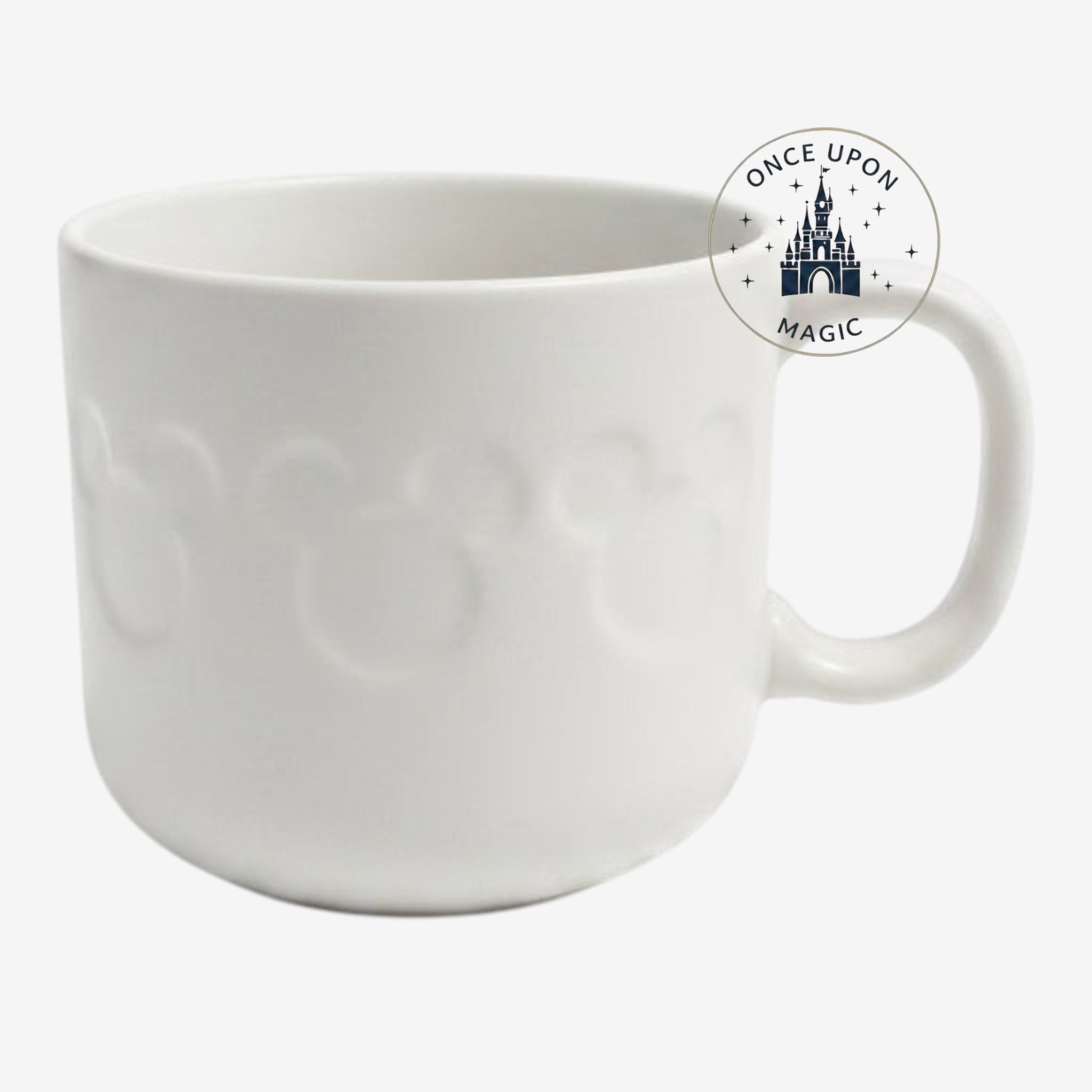 Once Upon Magic white ceramic mug from Disneyland Paris featuring a subtle embossed Mickey Mouse icon pattern