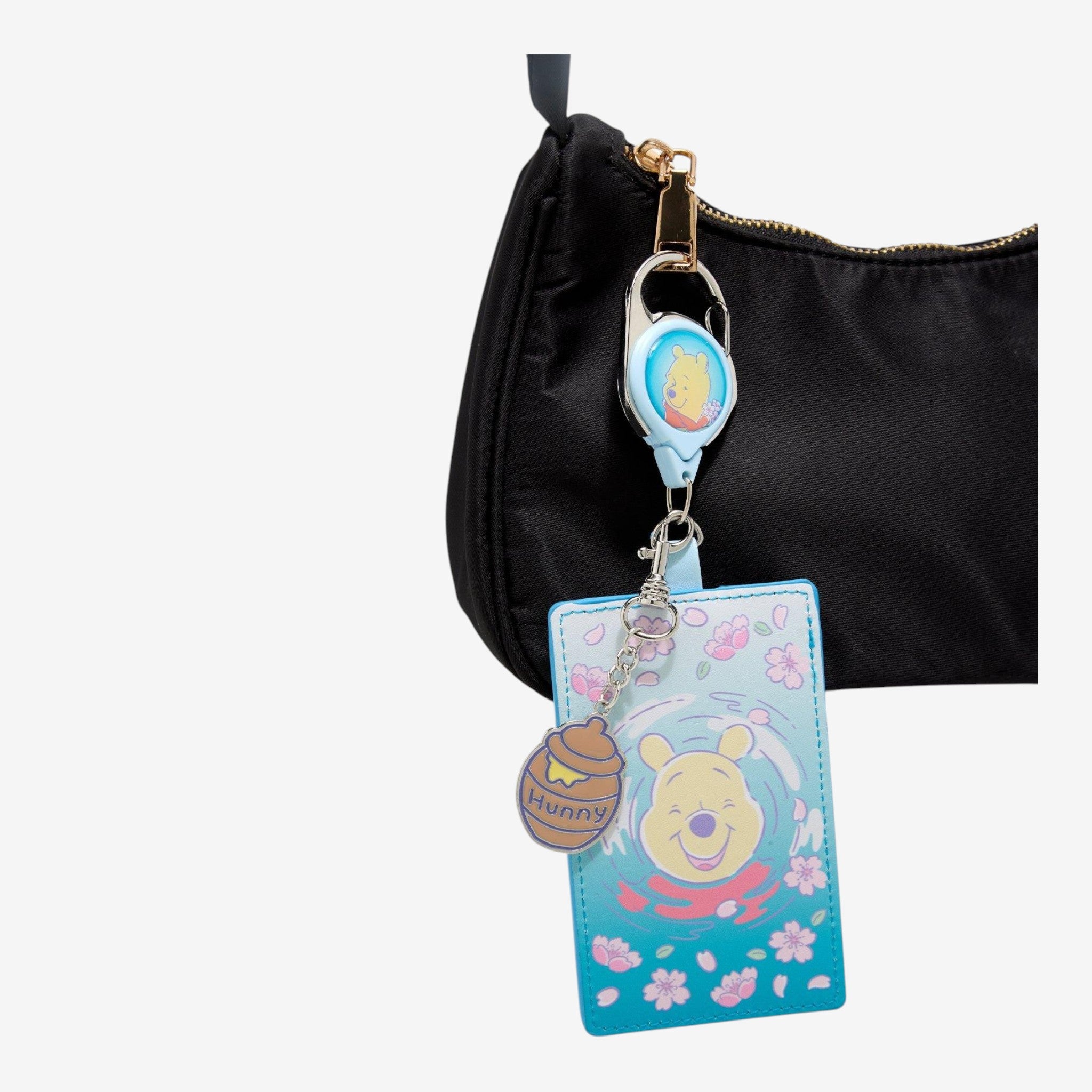 Once Upon Magic Disney Winnie the Pooh Sakura retractable lanyard with honey pot charm. Pastel pink and blue.