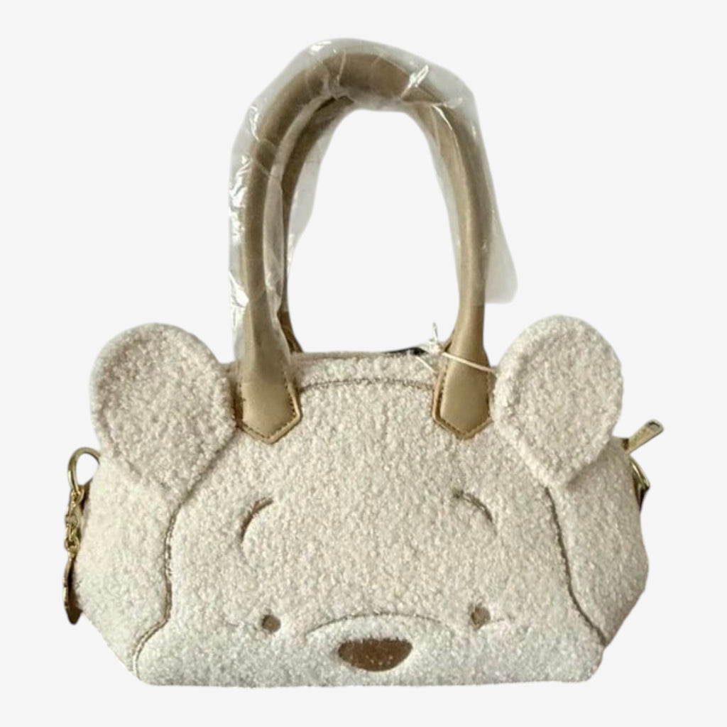 Once Upon Magic Winnie the Pooh sherpa mini duffel bag with embroidered face and ears, beige handles.