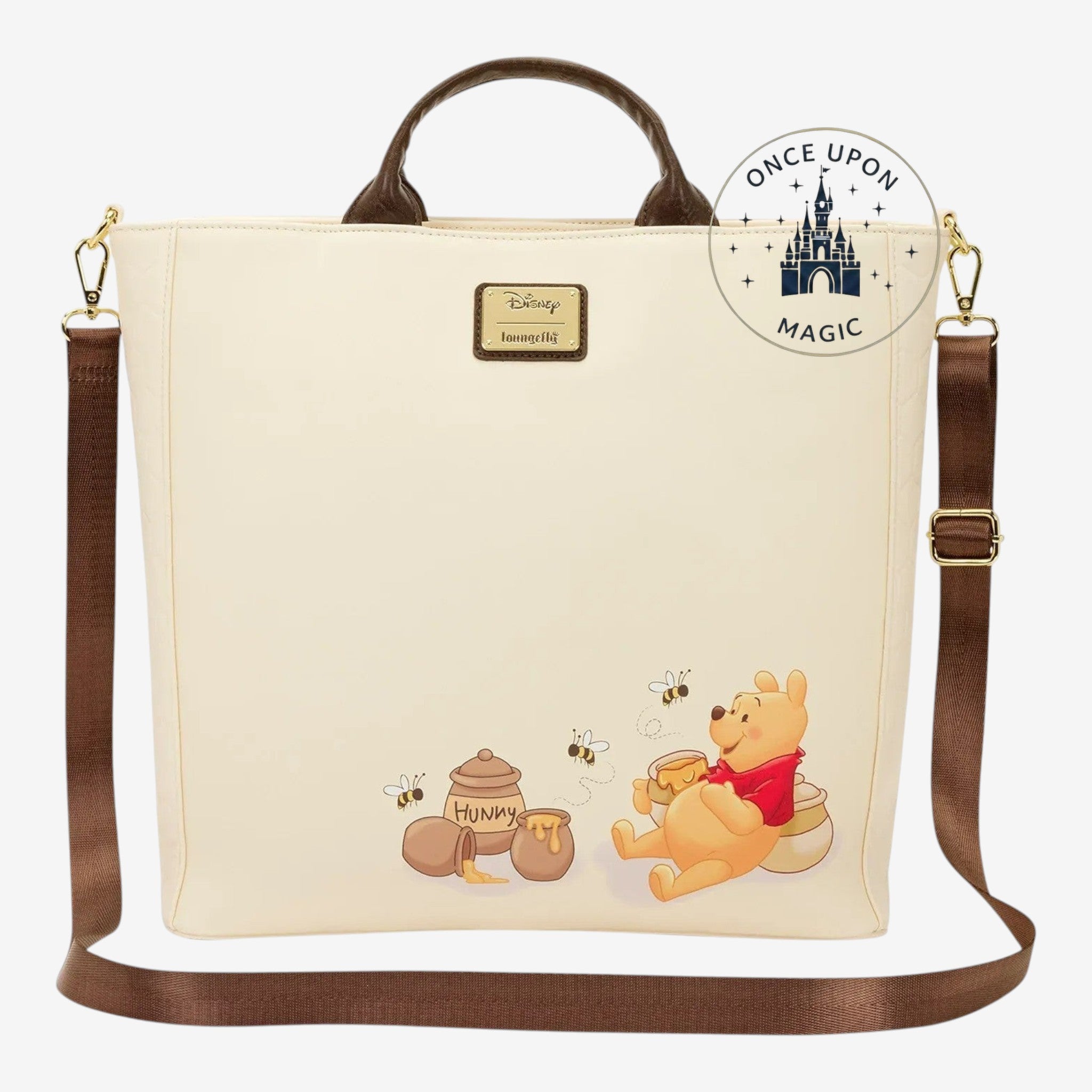 Once Upon Magic Winnie the Pooh tote bag in cream with Winnie the Pooh and honey pots graphic. Features brown handles and strap.