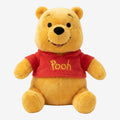 Once Upon Magic yellow plush Winnie the Pooh wearing a red shirt with "Pooh" embroidered in yellow.