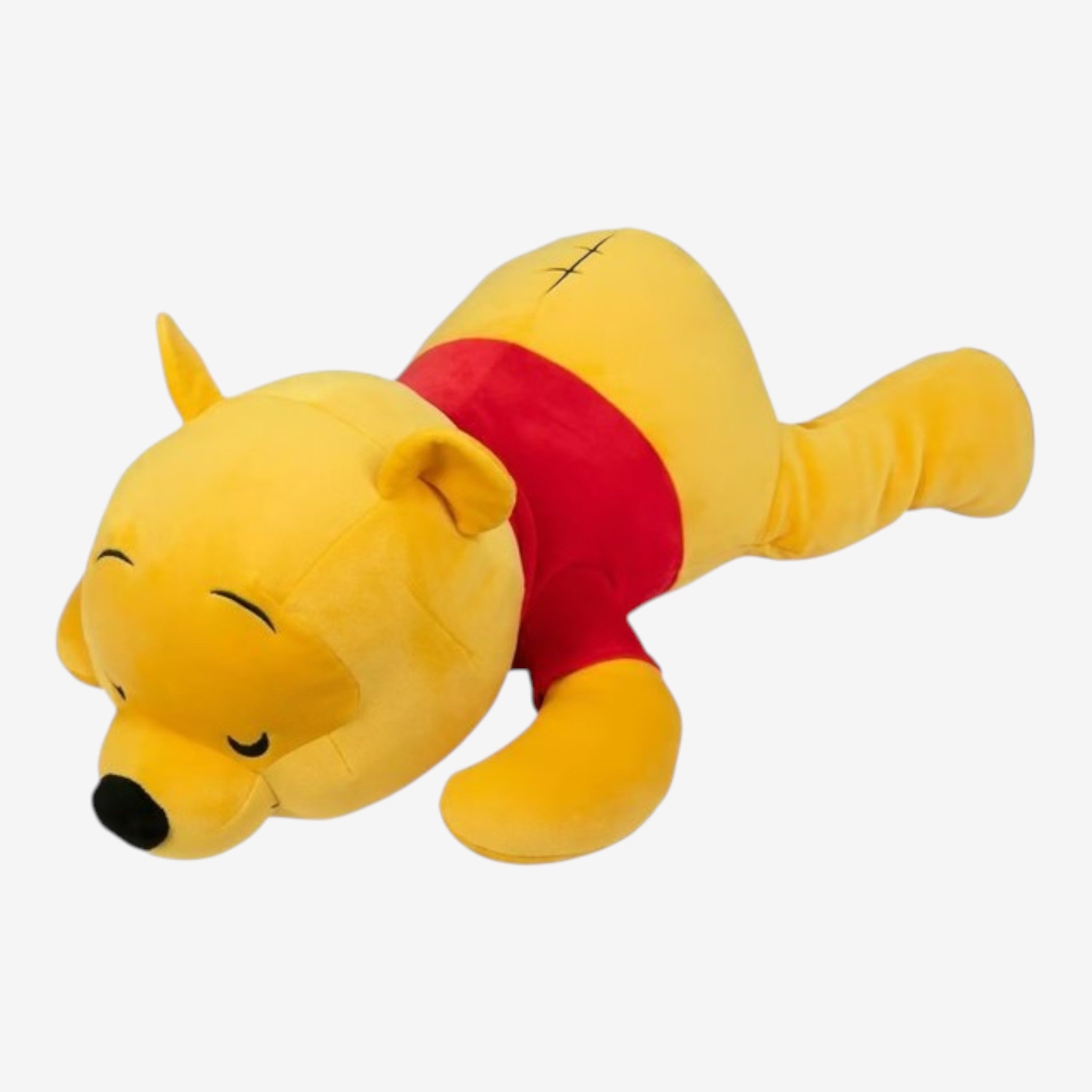 Once Upon Magic Winnie the Pooh plush toy in soft yellow with red shirt and black nose, lying down.