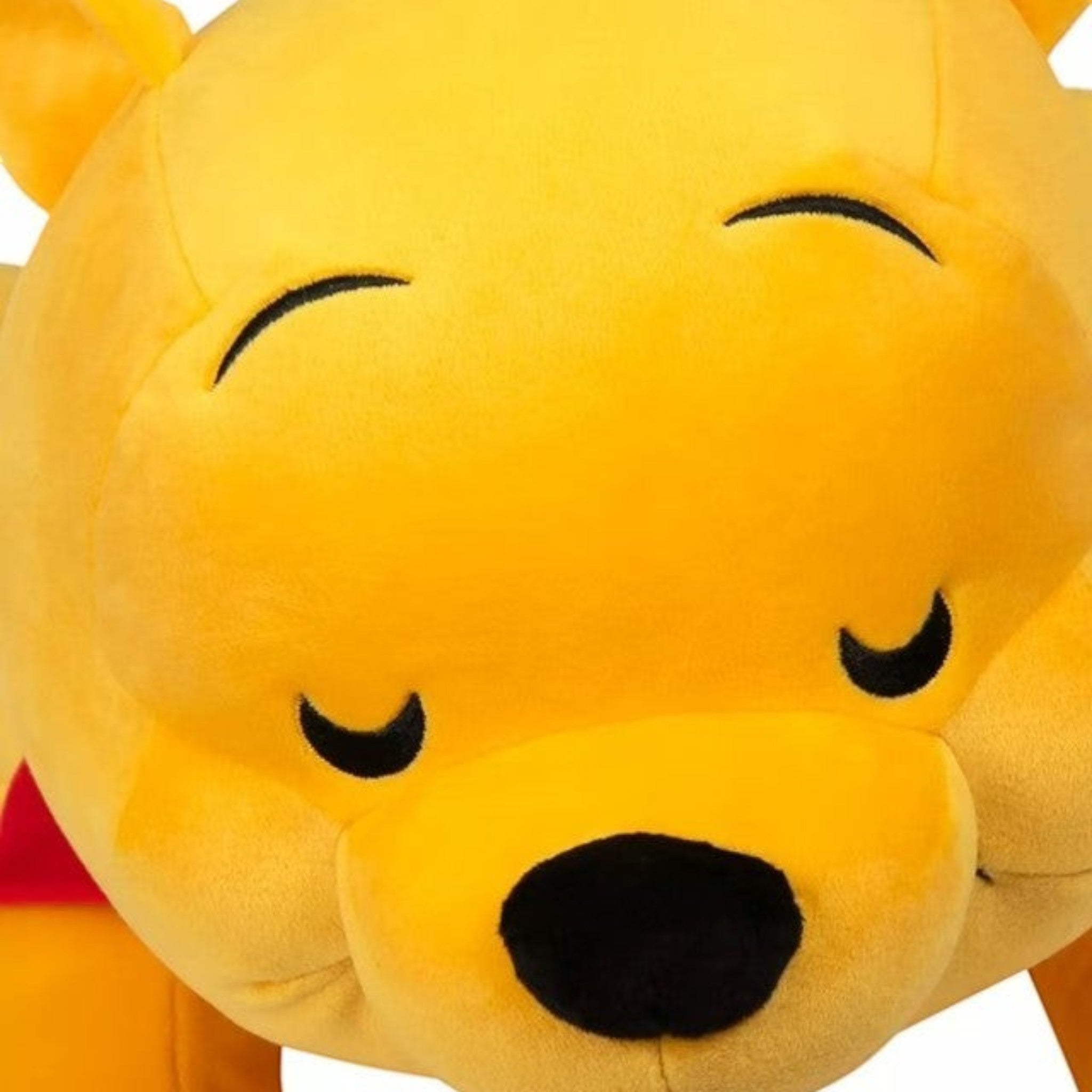 Once Upon Magic Winnie the Pooh plush toy in soft yellow material with a red shirt and friendly expression.