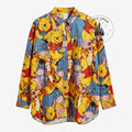 Once Upon Magic long-sleeve button-down shirt featuring a colorful Winnie the Pooh and friends all-over print