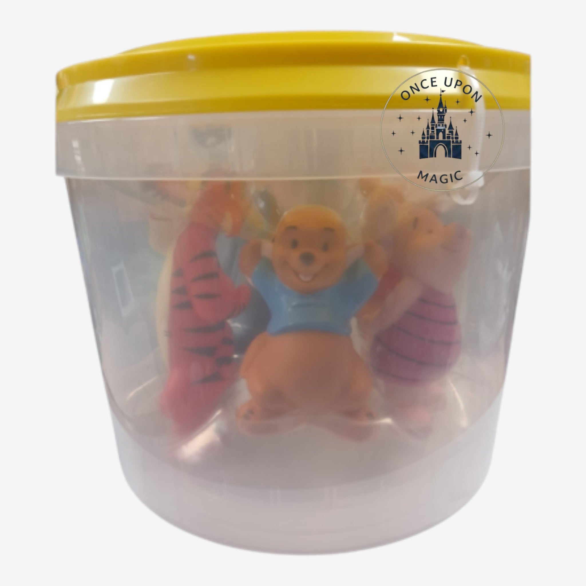 Once Upon Magic Winnie the Pooh character figurines inside a clear plastic storage bucket with a yellow lid.