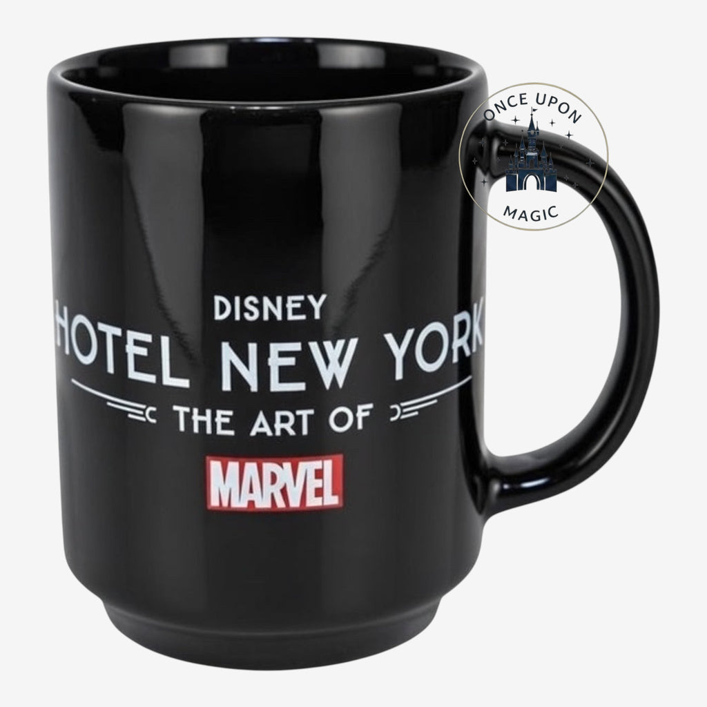 Once Upon Magic black ceramic mug featuring Disney Hotel New York The Art of Marvel logo and Marvel superhero silhouettes.