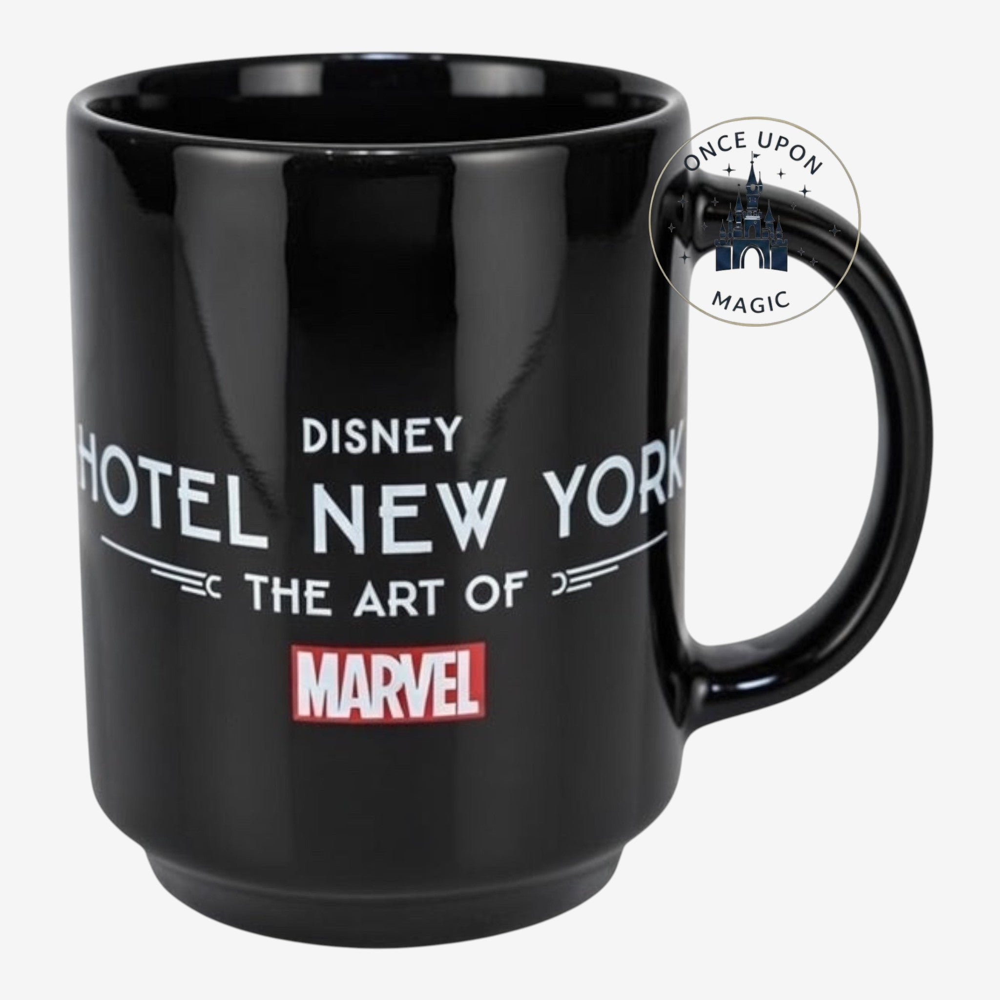 Once Upon Magic black ceramic mug featuring Disney Hotel New York The Art of Marvel logo and Marvel superhero silhouettes.