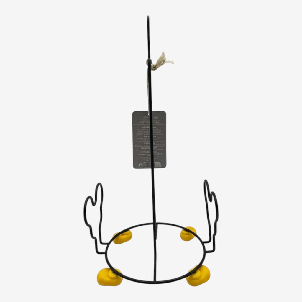 Once Upon Magic black metal paper towel holder with yellow feet accents. Decorative kitchen accessory.